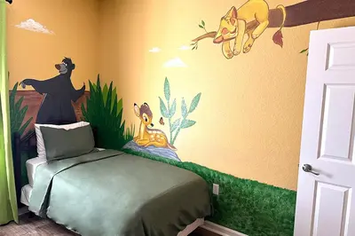a childs room with a disney bedroom with a bed at Lion King-themed condo near Disney, Sea World, Universal and OCCC with pool, spa, restaurants, shuttle, private balcony, and the BEST view of fireworks shows in Orlando