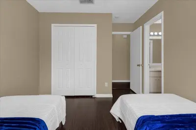 a bedroom with two beds and a white door at 5Bd 2 Bath with Gameroom & Pool 1 story House in Orlando