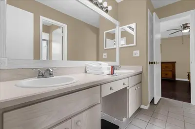 a bathroom with a sink and a mirror at 5Bd 2 Bath with Gameroom & Pool 1 story House in Orlando