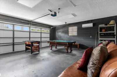 a room with a pool table and a couch in it at 5Bd 2 Bath with Gameroom & Pool 1 story House in Orlando