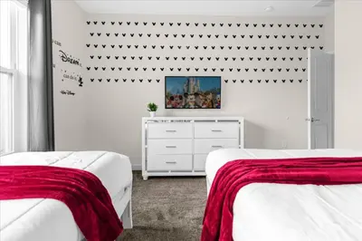 a white bedroom with two beds and a dresser at 5 Bedrroms 5 Bathrooms Storey Lake 2739 Bd in Kissimmee