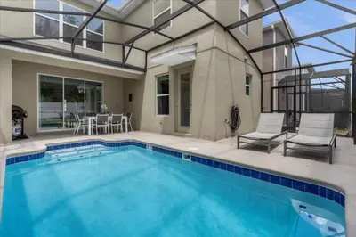 a swimming pool with a patio and a house at 5 Bedrroms 5 Bathrooms Storey Lake 2739 Bd in Kissimmee