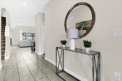 a hallway with a mirror and a table at 5 Bedrroms 5 Bathrooms Storey Lake 2739 Bd in Kissimmee