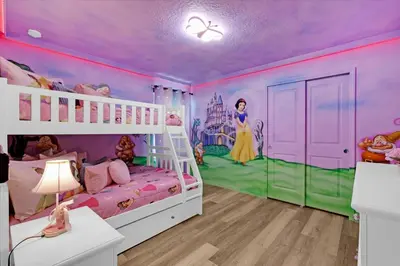 a childs bedroom with a disney princess mural at Villa Grande in Orlando