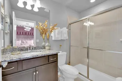 a bathroom with a toilet and a sink and a shower at Villa Grande in Orlando