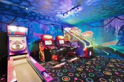a room with two arcade machines and a video game at Villa Grande in Orlando