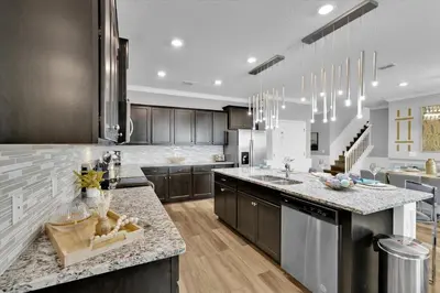 a large kitchen with a counter top and a kitchen island at Villa Grande in Orlando