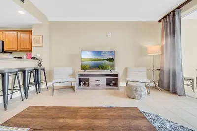 a living room with a flat screen tv on a wall at K and J Orlando in Orlando