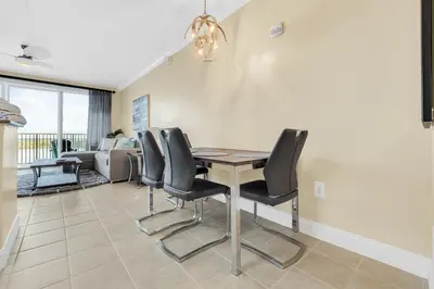 a dining room with a table and black chairs at K and J Orlando in Orlando
