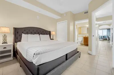 a bedroom with a large bed and a living room at K and J Orlando in Orlando