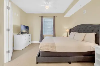 a bedroom with a large bed and a television at K and J Orlando in Orlando