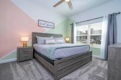 a bedroom with a bed and a window at Luxury Stay Near Disney Storey Lake Resort 2568 in Kissimmee