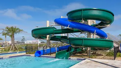a water slide at a resort with a pool at Lake View Cozy Home w/ Pool & Games Near Disney in Kissimmee