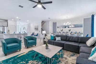 a living room with a couch and chairs and a kitchen at Magical 10-Bedroom Disney Getaway Awaits! in Kissimmee