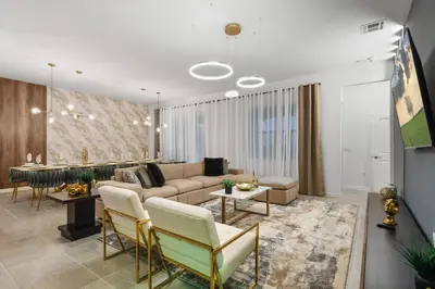 a living room with a couch and a table at Luxury 12BR Villa w/ Pool & Spa Near Disney in Kissimmee