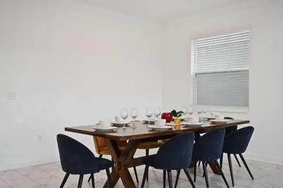 a dining room table with chairs and wine glasses at Luxurious Resort Home Near Disney & Shopping! in Kissimmee