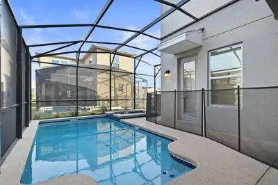 a swimming pool in a house with a glass ceiling at Luxurious Resort Home Near Disney & Shopping! in Kissimmee