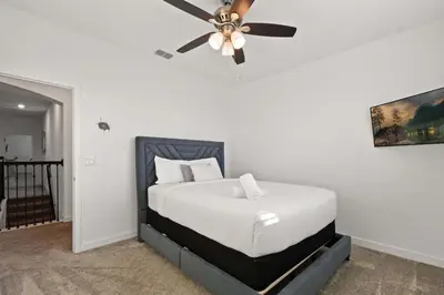 a bedroom with a bed with a ceiling fan at Luxurious Resort Home Near Disney & Shopping! in Kissimmee