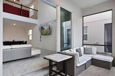a living room with a couch and a table at Luxurious Resort Home Near Disney & Shopping! in Kissimmee