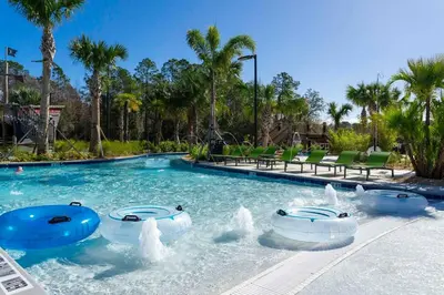a swimming pool with water fountains in a resort at Fantastic Mickey house Waterpark near Disney 2572 in Kissimmee
