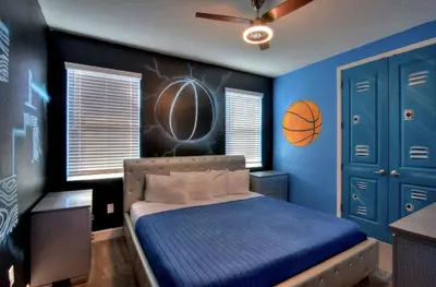 a bedroom with a basketball painted on the wall at All Vacation Mansion w Spa-Pool-Cinema Sleep 40 in Kissimmee