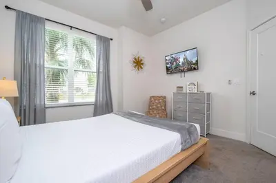 a bedroom with a large bed and a window at Comfortable home Near Disney & Private Pool 17414 in Orlando
