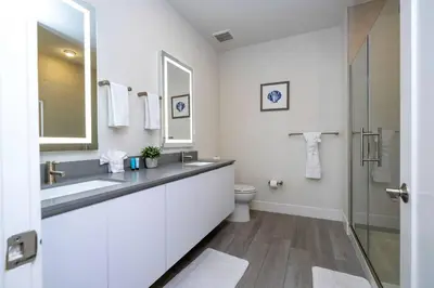a white bathroom with a sink and a toilet at Comfortable home Near Disney & Private Pool 17414 in Orlando