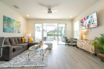 a living room with a couch and a table at Comfortable home Near Disney & Private Pool 17414 in Orlando