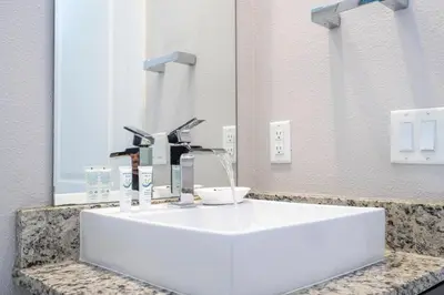 a white sink in a bathroom with a mirror at Stunning Villa 5 min to Disney in Orlando