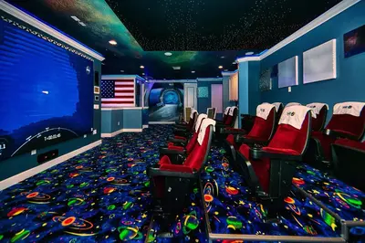 an empty movie room with red chairs and an american flag at Remarkable Mansion Sleep 36 Cinema-Bowling Alley & More in Kissimmee