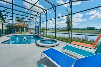 a swimming pool in a glass house with a view at Remarkable Mansion Sleep 36 Cinema-Bowling Alley & More in Kissimmee