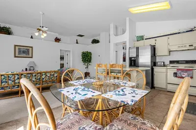 a dining room with a glass table and chairs at 2974 Viscount Villa 3bed Pool in Kissimmee