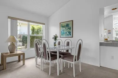 a dining room with a glass table and chairs at 2974 Viscount Villa 3bed Pool in Kissimmee