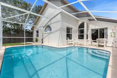 a swimming pool with blue water in a house at 2974 Viscount Villa 3bed Pool in Kissimmee
