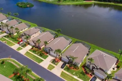 an overhead view of a house with a lake at 1061 Lake Berkley 4 Bed with Pool in Kissimmee