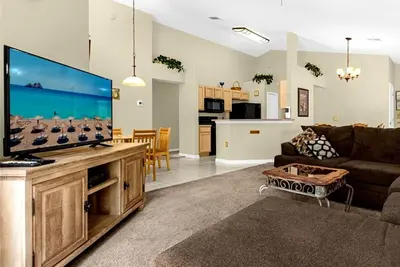 a living room with a large flat screen tv at 1061 Lake Berkley 4 Bed with Pool in Kissimmee