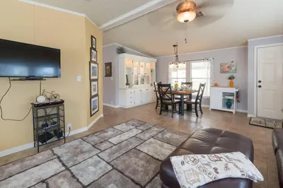 a living room with a couch and a table at Disney Backyard Oasis in Orlando