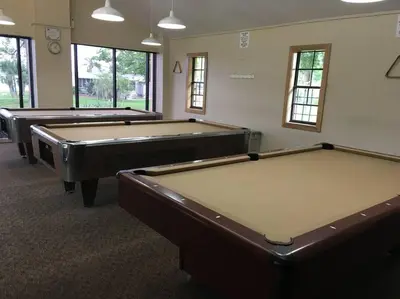 three pool tables in a room with windows at Disney Backyard Oasis in Orlando