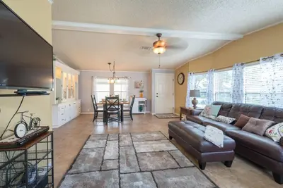 a living room with a couch and a table at Disney Backyard Oasis in Orlando