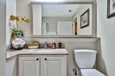 a bathroom with a sink and a mirror at Sunshine Oasis - Orlando Lakefront Luxury in Orlando