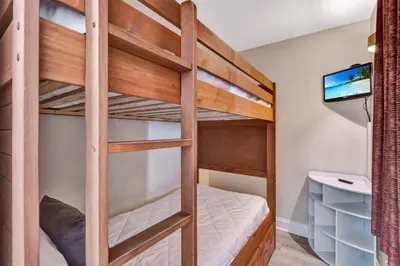 a bunk bed in a tiny room with a tv at Sunshine Oasis - Orlando Lakefront Luxury in Orlando