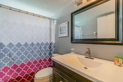 a bathroom with a sink and a toilet and a mirror at HARRY POTTER LIVES HERE! Unforgettable Home, Pool, Sleeps 8, Near Dis, LOW Rates! in Kissimmee