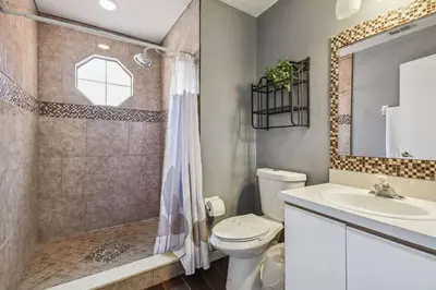 a bathroom with a toilet and a sink and a shower at FABULOUS New Decor, Near Dis, Fireplace, Star Wars Children's BR, Next To Pool, LOW rates! in Kissimmee