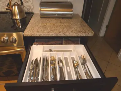 a kitchen sink with silver utensils in a drawer at SPECTACULAR, NEW Professional Decor, Near Dis, NO Steps, Pool, Patio, LOW Rates! in Kissimmee