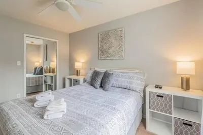 a bedroom with a bed with towels on it at SPECTACULAR, NEW Professional Decor, Near Dis, NO Steps, Pool, Patio, LOW Rates! in Kissimmee