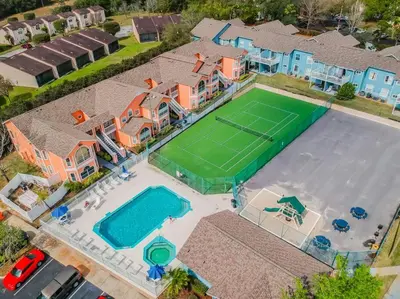 an overhead view of a house with a tennis court at SPECTACULAR, NEW Professional Decor, Near Dis, NO Steps, Pool, Patio, LOW Rates! in Kissimmee