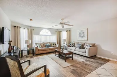 a living room with two couches and a tv at SPECTACULAR, NEW Professional Decor, Near Dis, NO Steps, Pool, Patio, LOW Rates! in Kissimmee