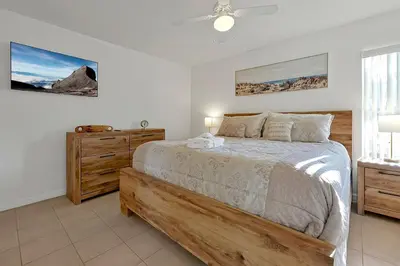 a bedroom with a bed and a ceiling fan at Spacious Condo W/ Pool,Gym near Disney & Seaworld in Kissimmee