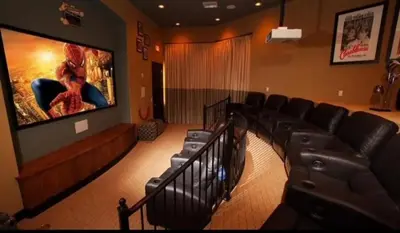 a room with a theater with a large screen at Cozy 4bdhome By Lake Prime Location Disney in Kissimmee