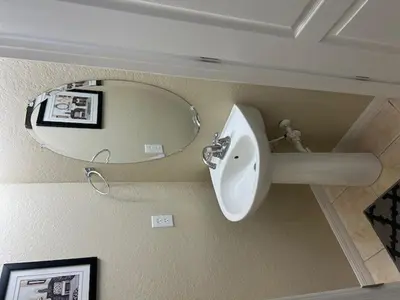 a bathroom with a sink and a mirror at Cozy 4bdhome By Lake Prime Location Disney in Kissimmee